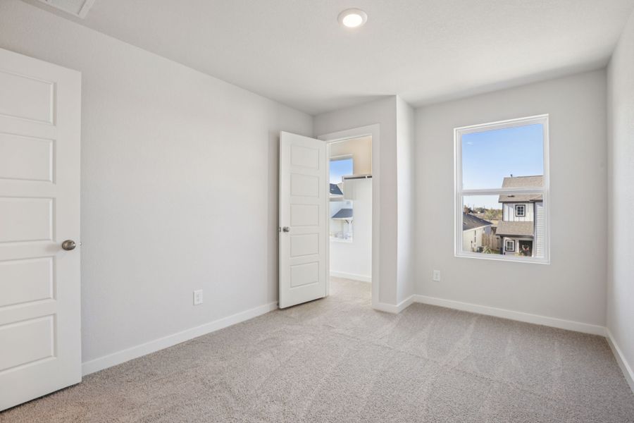 A room with white walls and a window.