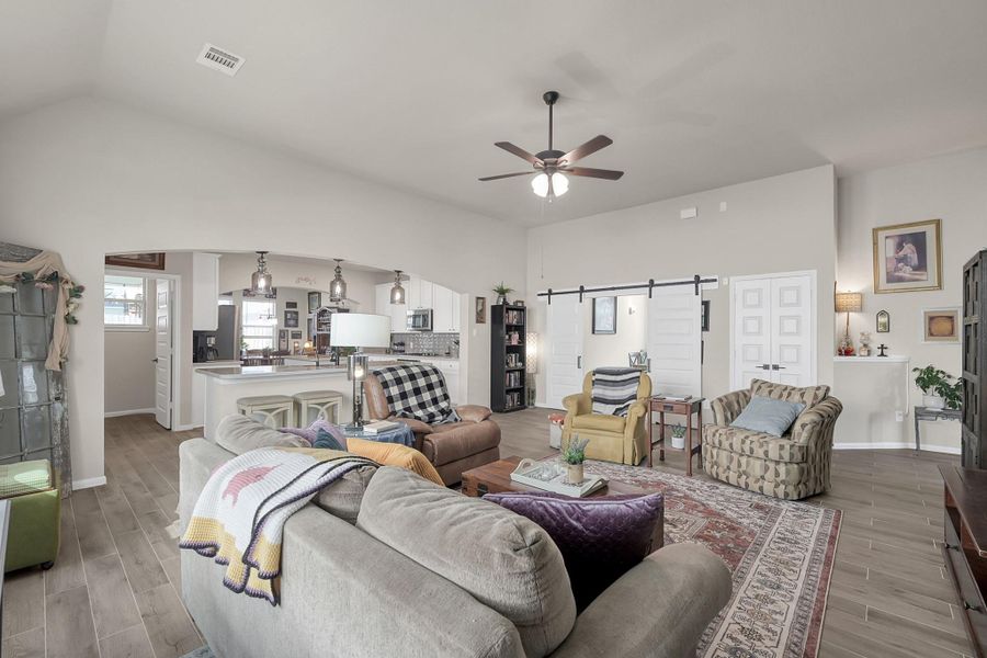 Notice the barn doors in the back of the photo leading into the spacious flex room!