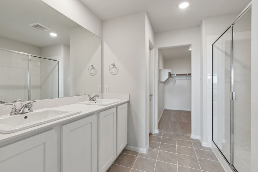 Primary Bathroom in the Hayden home plan by Trophy Signature Homes – REPRESENTATIVE PHOTO