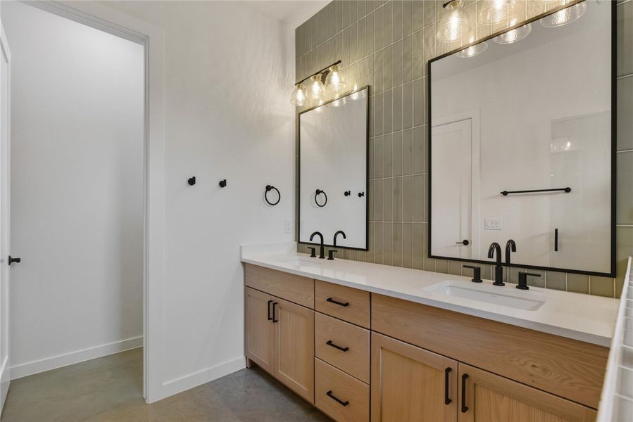 Full bath with double vanity and finished concrete floors Full bath with double vanity and finished concrete floors
