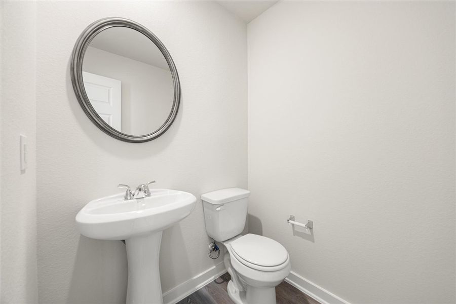This half bath features a clean, minimalist design with neutral tones and a pedestal sink. Bright and polished, it offers a simple yet elegant touch for guests and everyday use. This half bath features a clean, minimalist design with neutral tones and a pedestal sink. Bright and polished, it offers a simple yet elegant touch for guests and everyday use.
