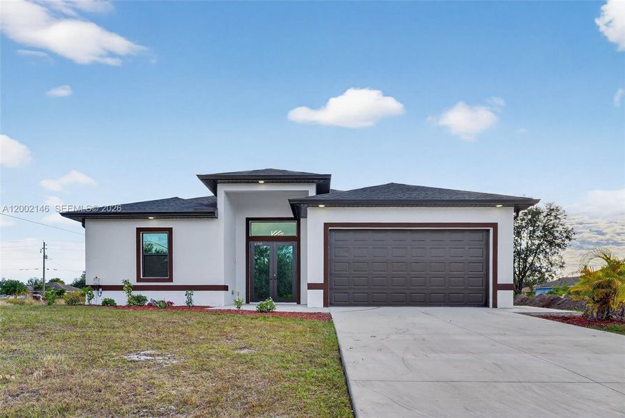 Front exterior of a new home in , Lehigh Acres, FL, highlighting curb appeal (Image 21).