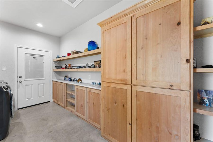 Pantry with knotty alder cabinetry and extra storage/shelving.