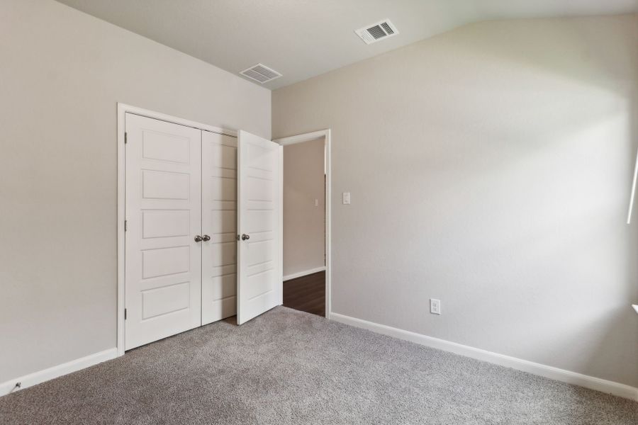 Guest bedroom in the Hughes floorplan at a Meritage Homes community.