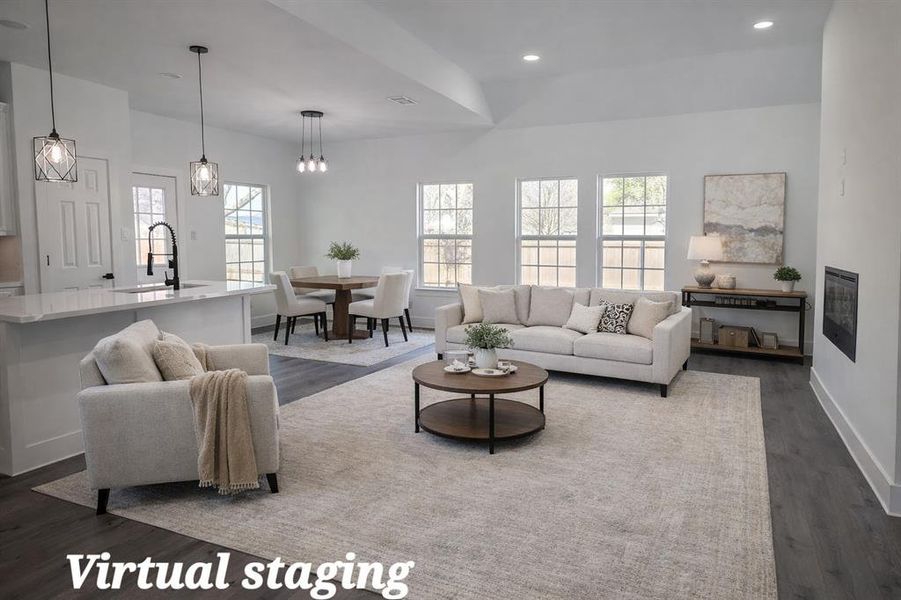 Living area with dark wood-style flooring, healthy amount of natural light, and recessed lighting