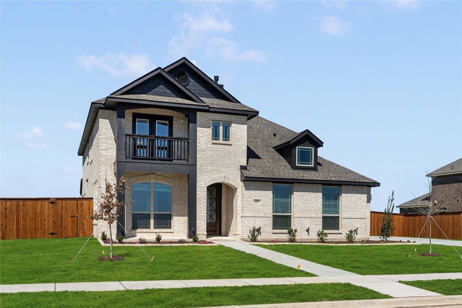 Two-story brick home with dark trim, second-floor balcony, arched entry, and manicured front lawn Two-story brick home with dark trim, second-floor balcony, arched entry, and manicured front lawn