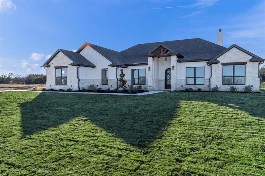 View of front of property with a front lawn