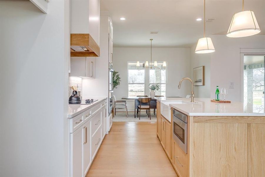 Open kitchen with stain grade white oak island
