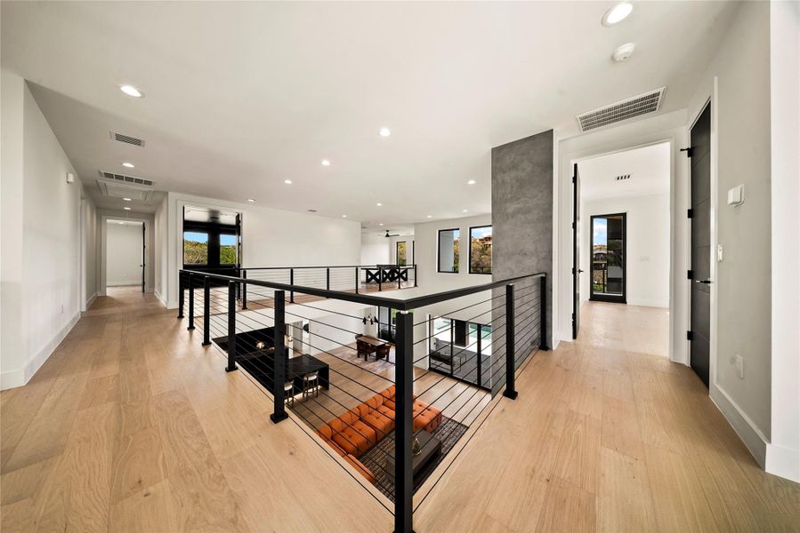 Hall with light wood-type flooring, recessed lighting, and an upstairs landing Hall with light wood-type flooring, recessed lighting, and an upstairs landing