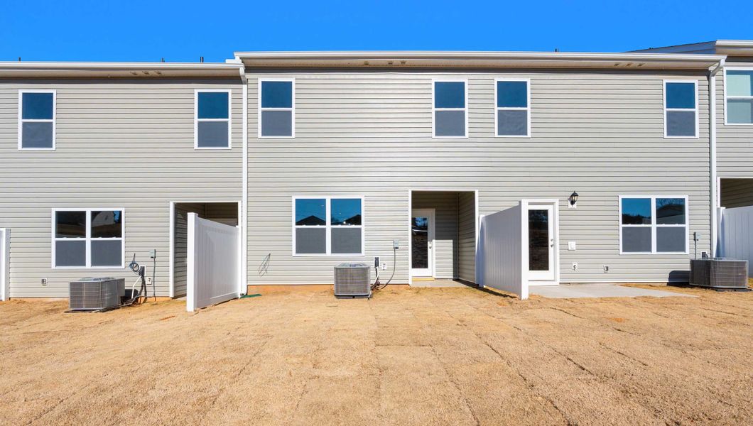 Exterior details and patio area of a home in Tanglewood Townes, Greenville (Image 2). Exterior details and patio area of a home in Tanglewood Townes, Greenville (Image 2).