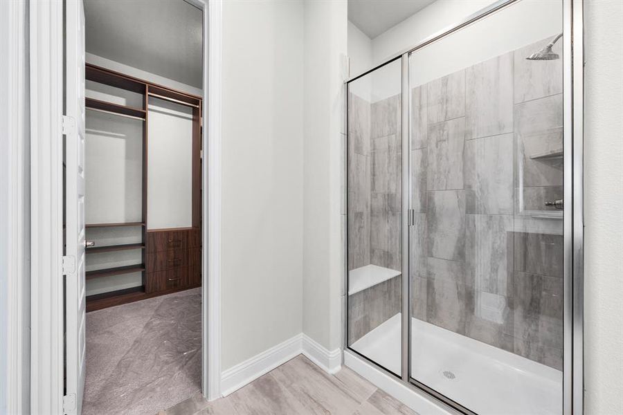 Bathroom with a stall shower and wood finished floors Bathroom with a stall shower and wood finished floors