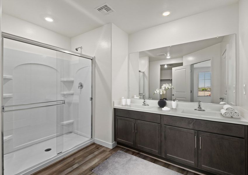 The master bathroom features a glass-enclosed shower and luxurious finishes. The master bathroom features a glass-enclosed shower and luxurious finishes.