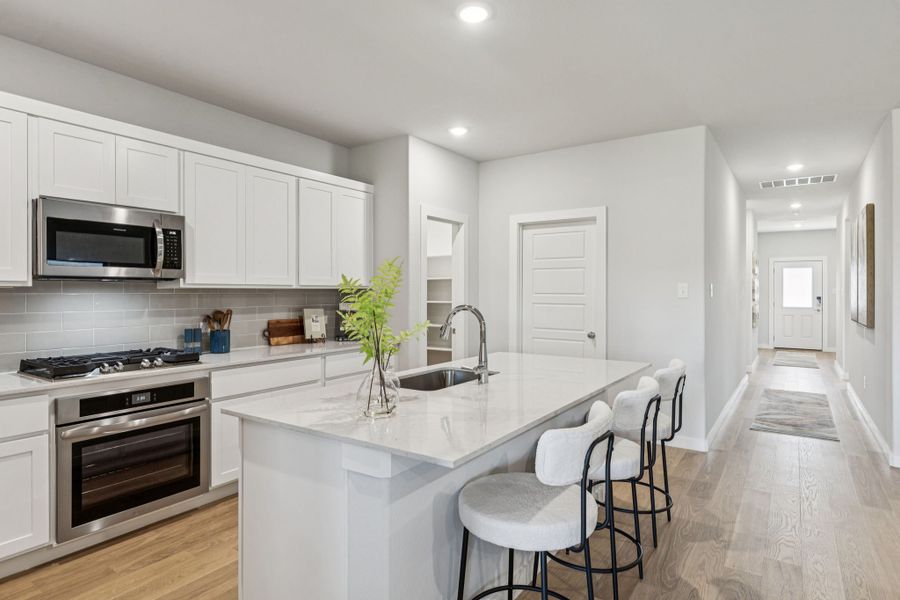 Kitchen in the Oscar home plan by Trophy Signature Homes – REPRESENTATIVE PHOTO