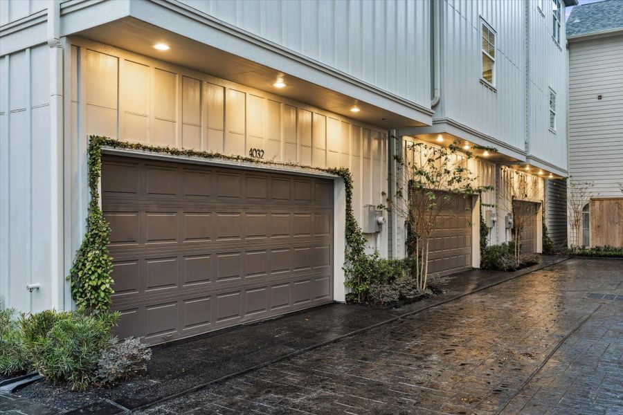 Two-car-garage with with epoxy flooring, stampled concrete driveway and phot ocell lighting.