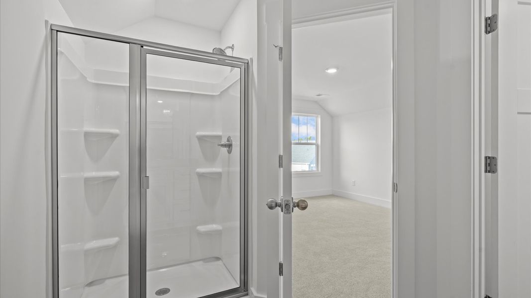 Accomplished full bath with walk-in shower designed with both comfort and sophistication in mind