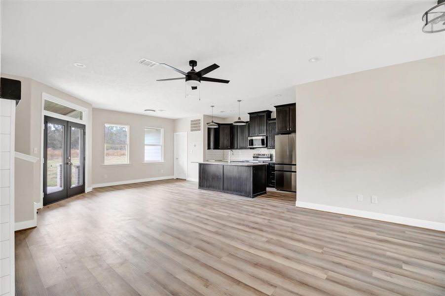 View from family room into the kitchen area. Love the dark cabinets and the refrigerator is included.