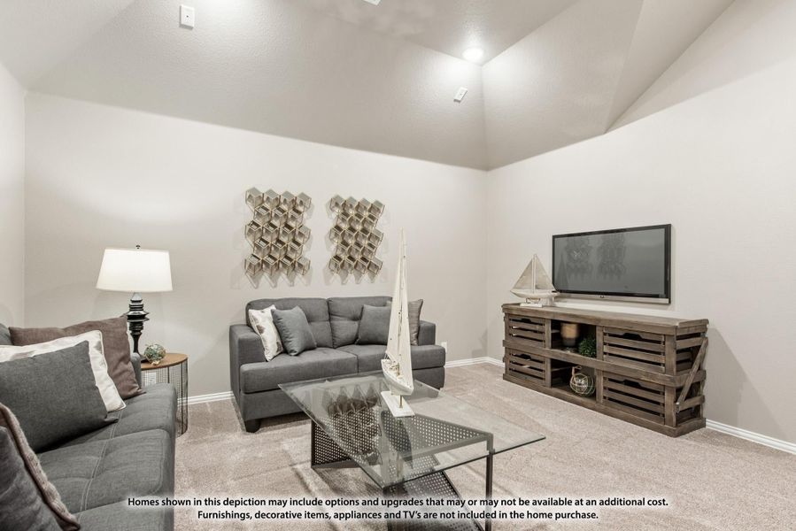 Living room with gray sofas, glass coffee table, wood TV stand, and vaulted ceiling with carpet flooring Living room with gray sofas, glass coffee table, wood TV stand, and vaulted ceiling with carpet flooring