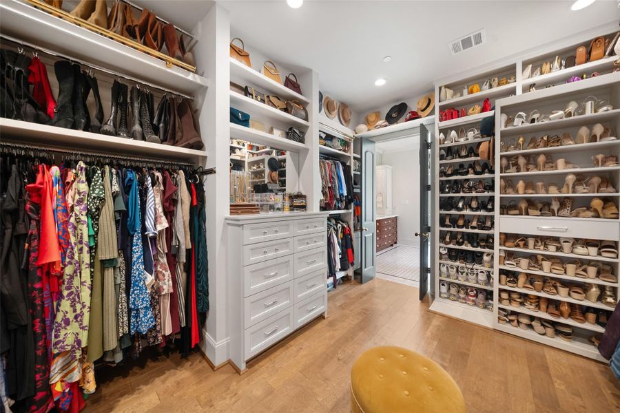 Spacious primary walk-in closet, featuring adjustable shelves that can be moved left or right, allowing for a customizable storage solution tailored to your needs.