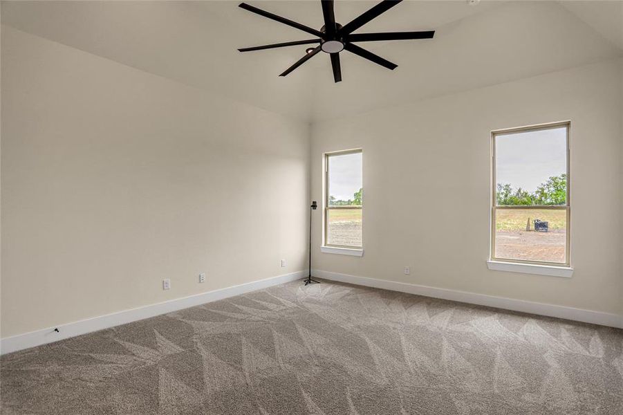 Unfurnished room featuring carpet flooring and ceiling fan Unfurnished room featuring carpet flooring and ceiling fan