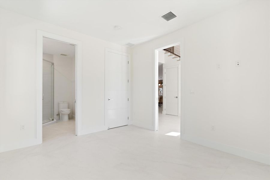 Main floor 4th bedroom with entry way to foyer  and guest bathroom