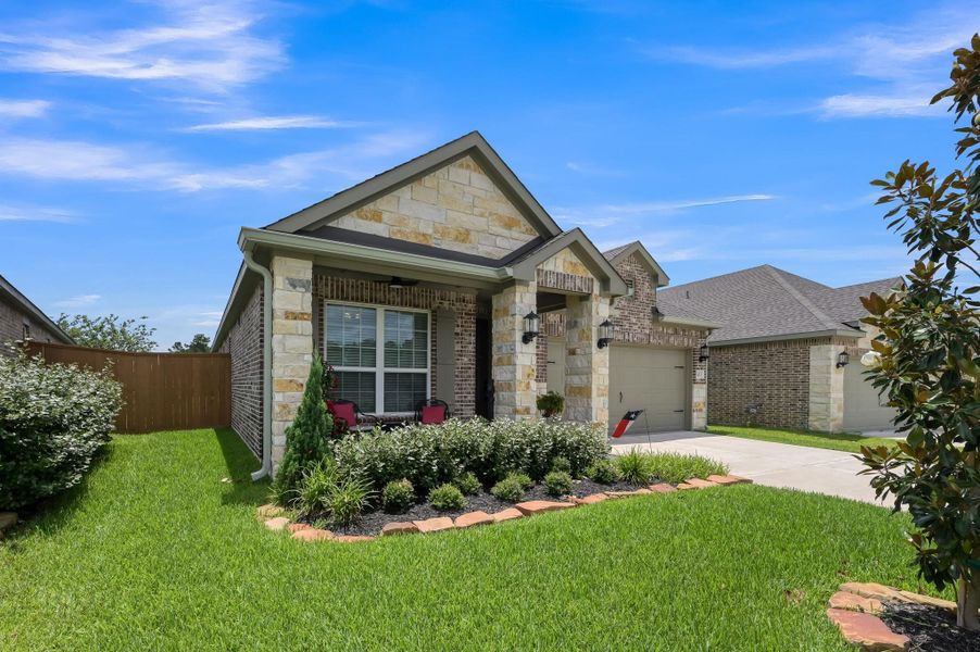 Inviting covered front porch and beautifully landscaped front yard complement the home's attractive brick-and-stone exterior, creating exceptional curb appeal and a warm welcome home. Inviting covered front porch and beautifully landscaped front yard complement the home's attractive brick-and-stone exterior, creating exceptional curb appeal and a warm welcome home.