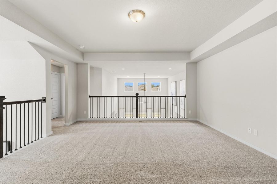 Your spacious second-floor game room overlooks the main living area below, providing a versatile space for a media room, play area, home office, or additional family gathering space.