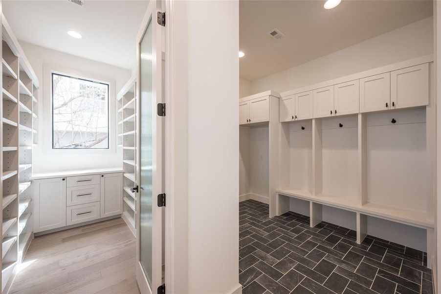 Nestled between the pantry and the garage, a large mudroom with storage cubbies and bench seating facilitates efficient arrivals and departures.