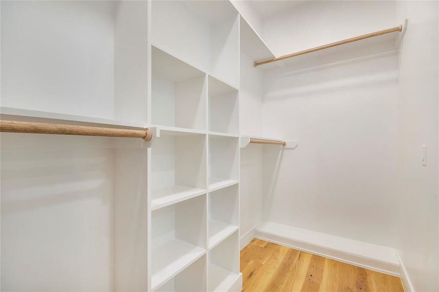 Spacious closet featuring light wood-style flooring