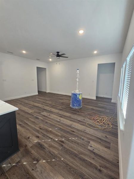 Unfurnished living room featuring recessed lighting, dark wood-style floors, and a ceiling fan