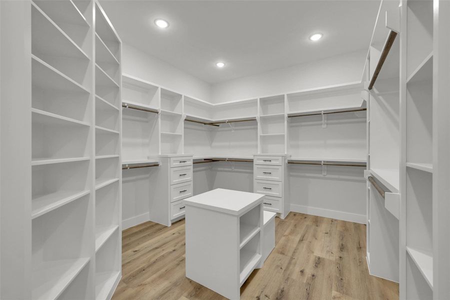 Massive walk-in closet with custom built-ins and abundant storage Massive walk-in closet with custom built-ins and abundant storage