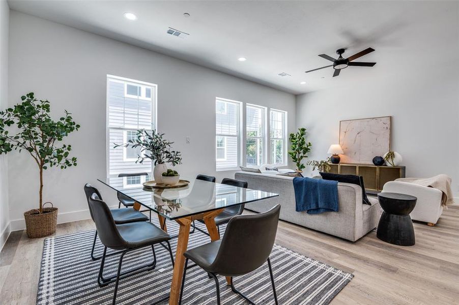 Dining room with light wood-style flooring, ceiling fan, and recessed lighting