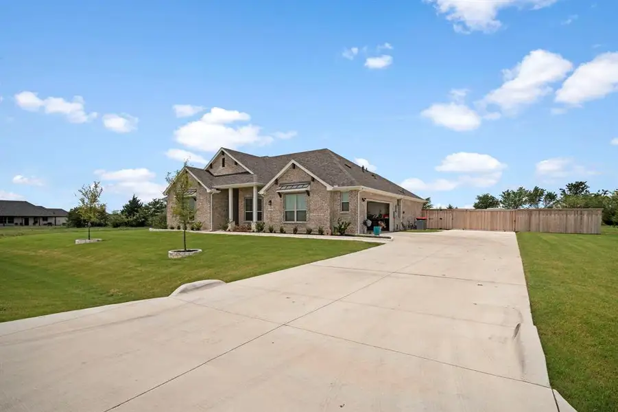 Front exterior of a new home in , Waxahachie, TX, highlighting curb appeal (Image 20).