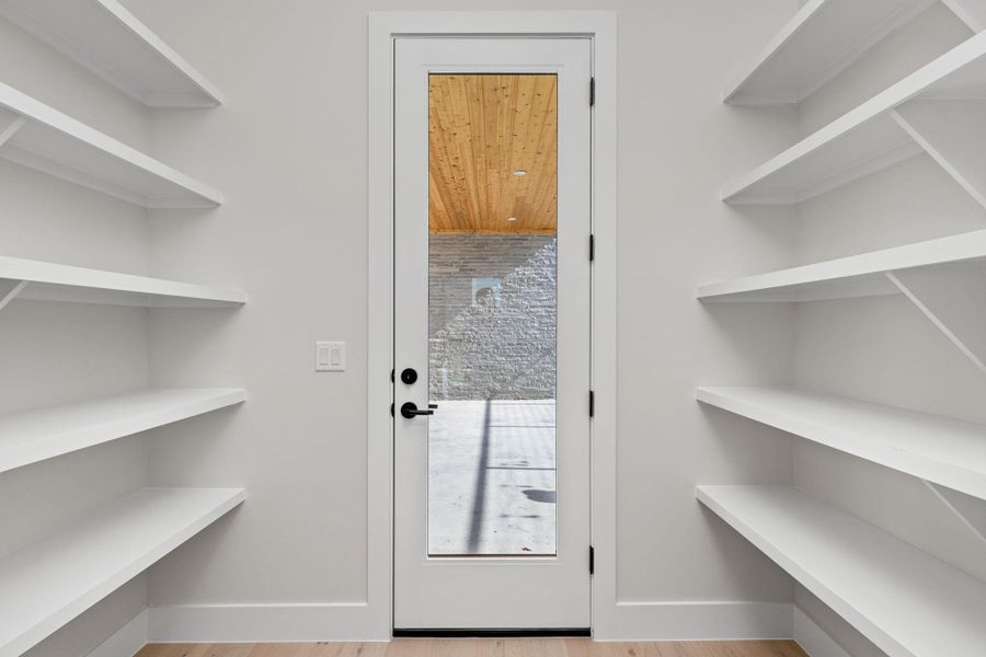 Doorway to outside with baseboards and wood finished floors