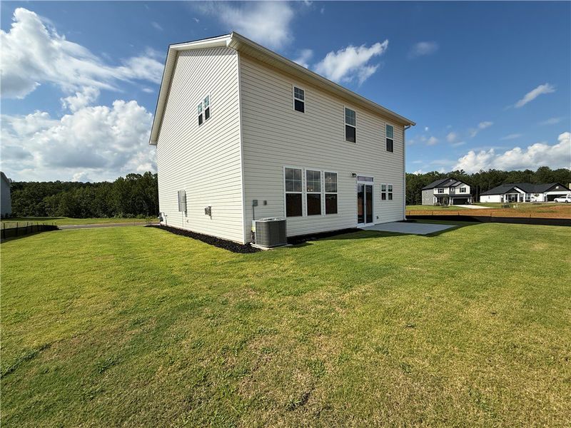 A well-maintained lawn extends from a freshly buil A well-maintained lawn extends from a freshly buil