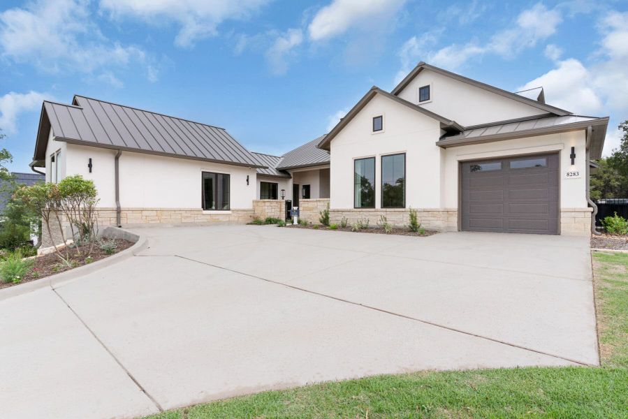 Front exterior of a new home in Enchanted Bluff, Garden Ridge, TX, highlighting curb appeal (Image 24).