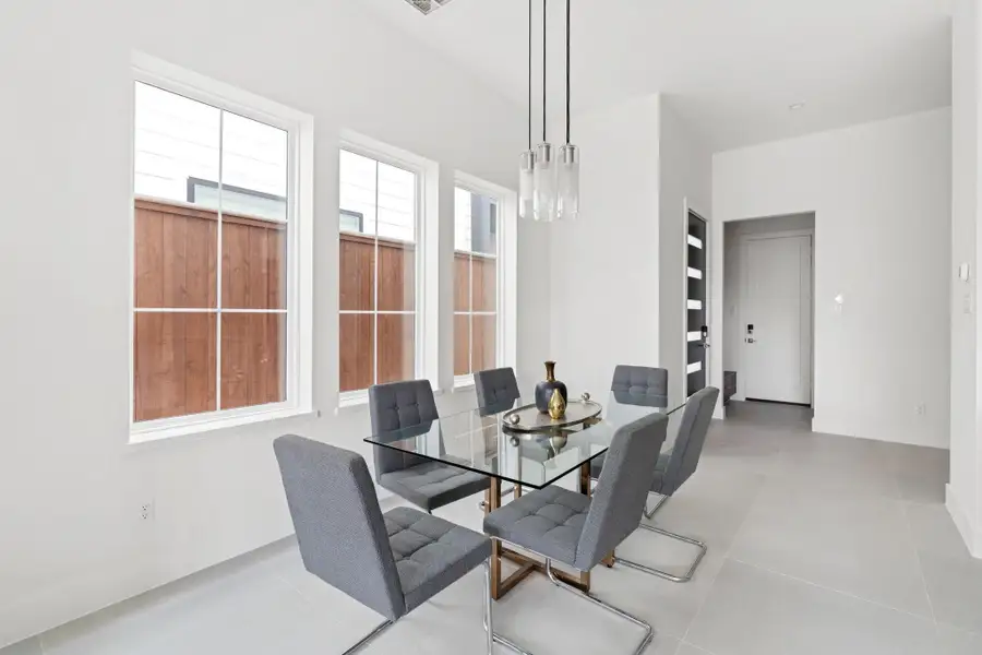 Sophisticated dining area bathed in natural light from oversized windows, creating the perfect ambiance for entertaining Sophisticated dining area bathed in natural light from oversized windows, creating the perfect ambiance for entertaining