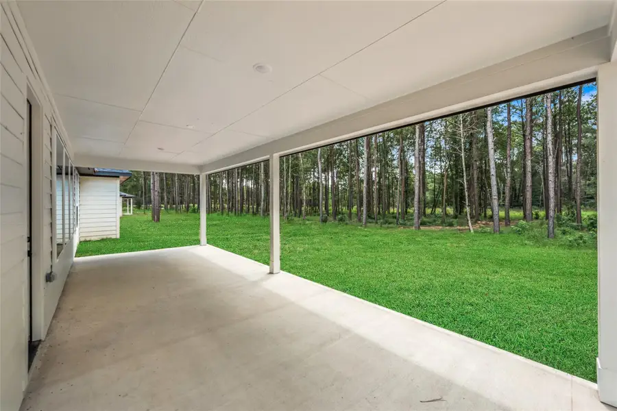 Exterior details and patio area of a home in Deer Pines, Conroe (Image 4).