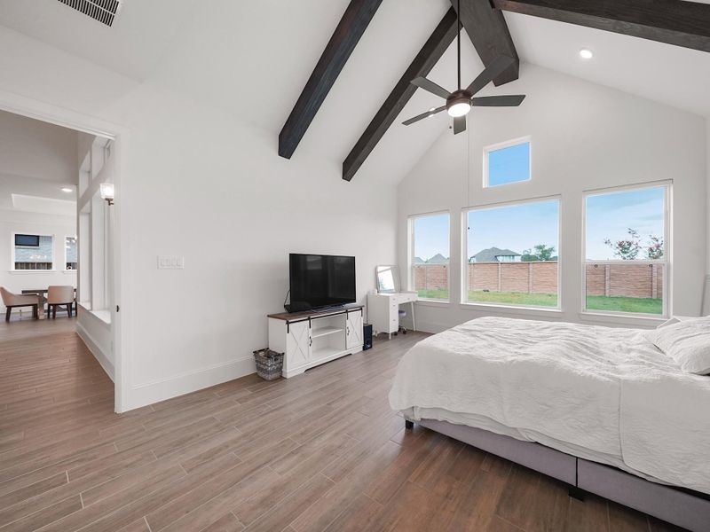 From this angle, you see how natural light floods the room, highlighting the airy design and seamless connection to the luxurious ensuite bath.