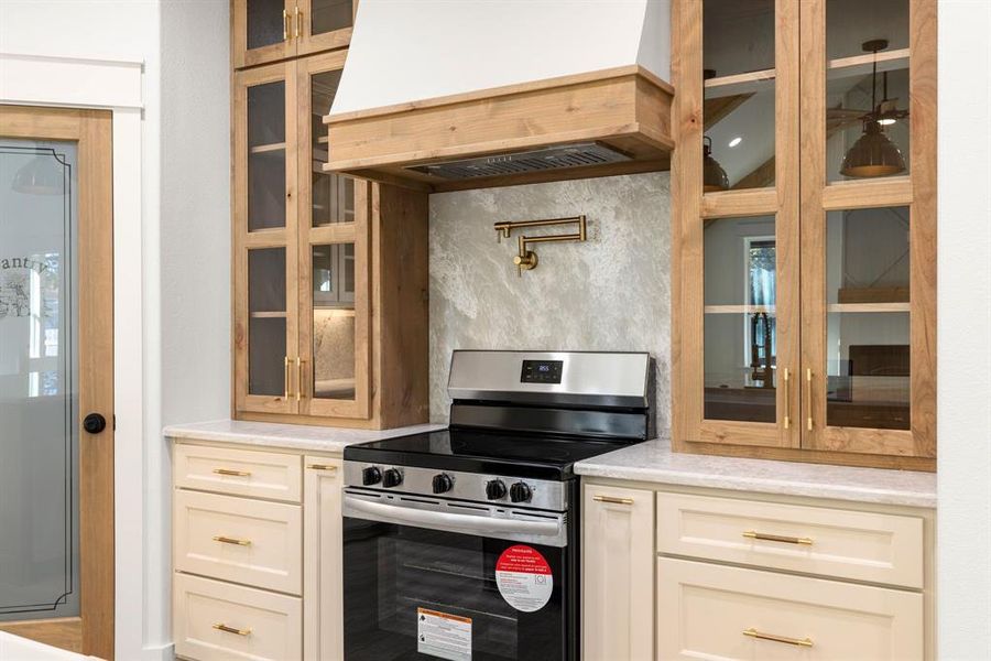 Kitchen with premium range hood and stainless steel range