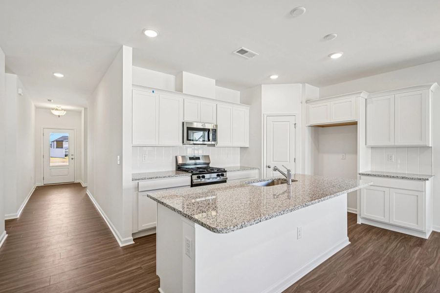 Kitchen - Chic white finishes and smooth surfaces shine.