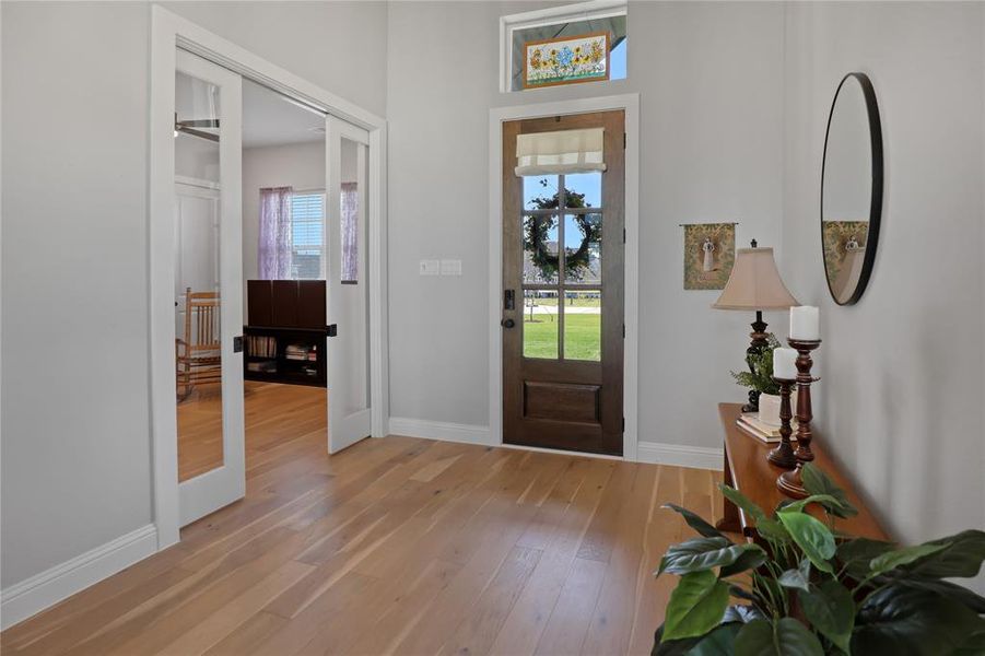 Entryway featuring light wood-type flooring, plenty of natural light, and baseboards Entryway featuring light wood-type flooring, plenty of natural light, and baseboards