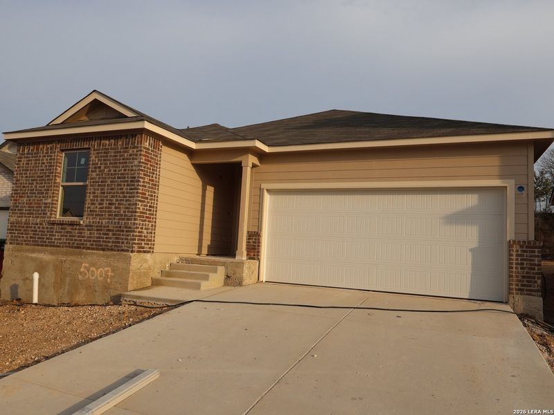 Front exterior of a new home in Agave, San Antonio, TX, highlighting curb appeal (Image 1). Front exterior of a new home in Agave, San Antonio, TX, highlighting curb appeal (Image 1).