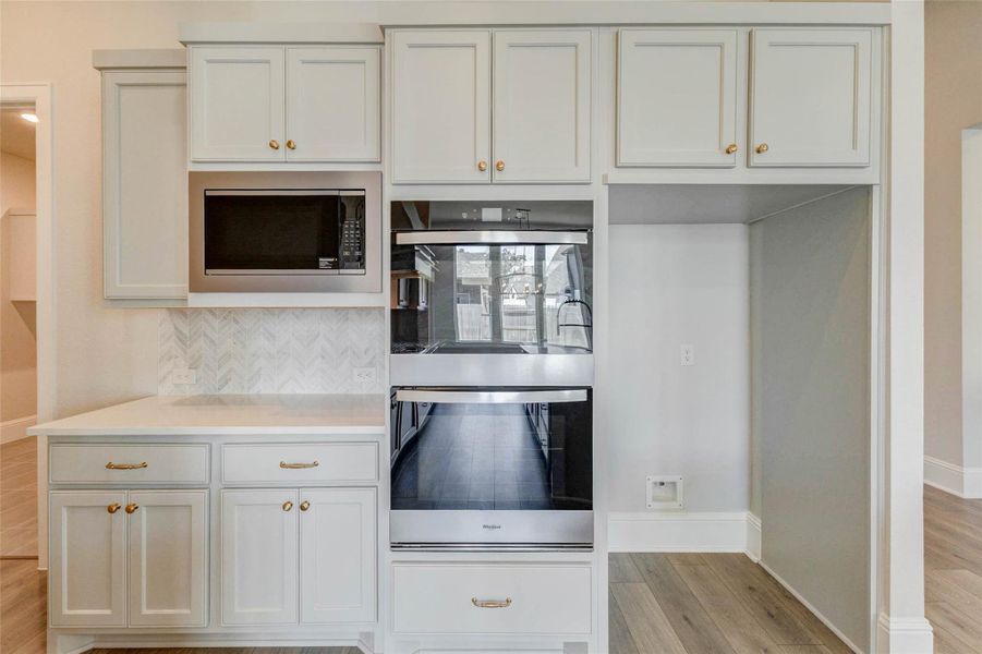 Double ovens, a built in microwave and built in cabinets for your future refrigerator.