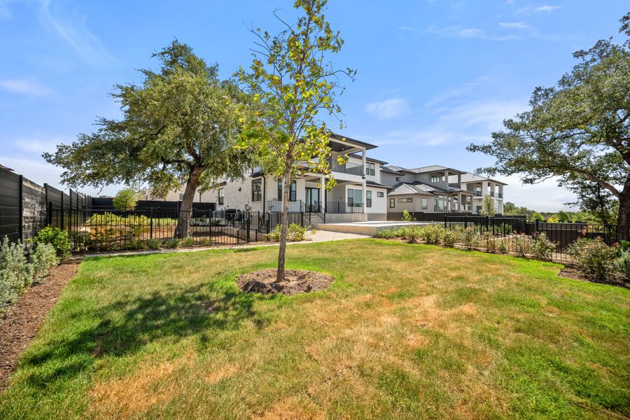 Front exterior of a new home in Milky Way at River Place, Austin, TX, highlighting curb appeal (Image 15). Front exterior of a new home in Milky Way at River Place, Austin, TX, highlighting curb appeal (Image 15).