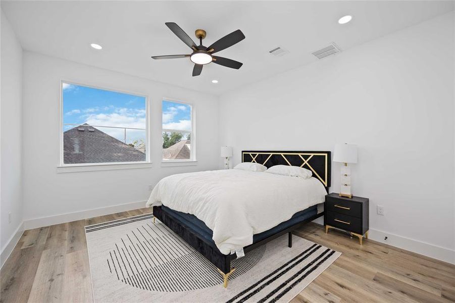 The primary bedroom is large and has beautiful windows that bring in natural light. There is no carpet in the entire home. A ceiling fan keeps this room cool in the Texas summer months.