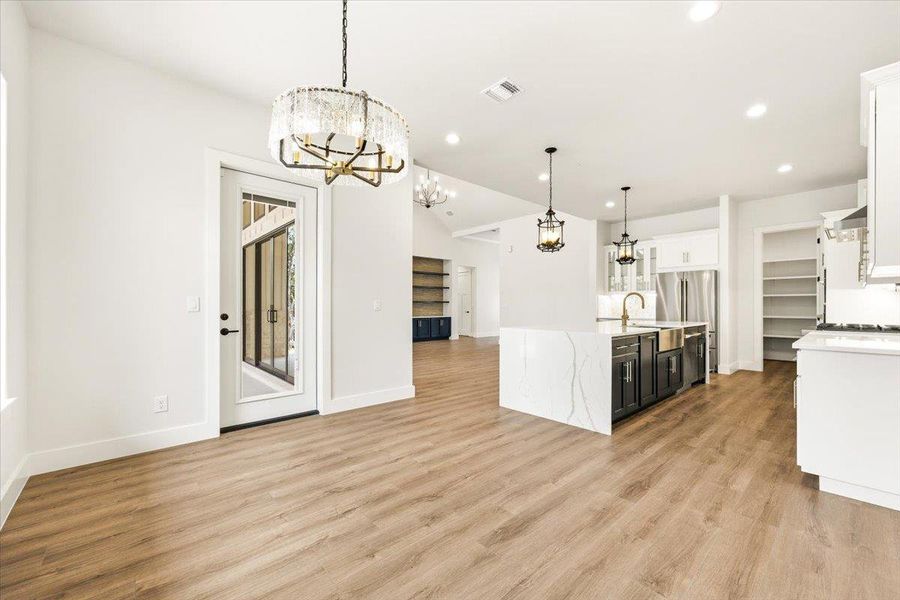 A modern kitchen island with a waterfall edge anchors this open-concept living area.