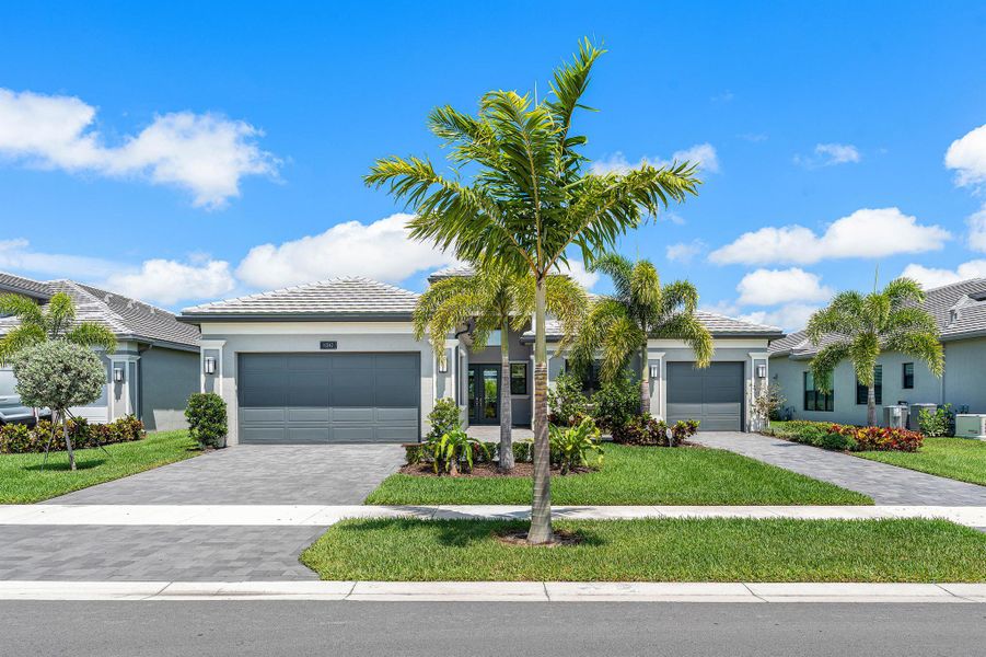 Front exterior of a new home in Valencia Grand, Boynton Beach, FL, highlighting curb appeal (Image 22). Front exterior of a new home in Valencia Grand, Boynton Beach, FL, highlighting curb appeal (Image 22).