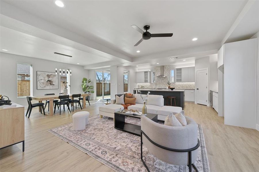 Living room featuring ceiling fan and light hardwood / wood-style flooring