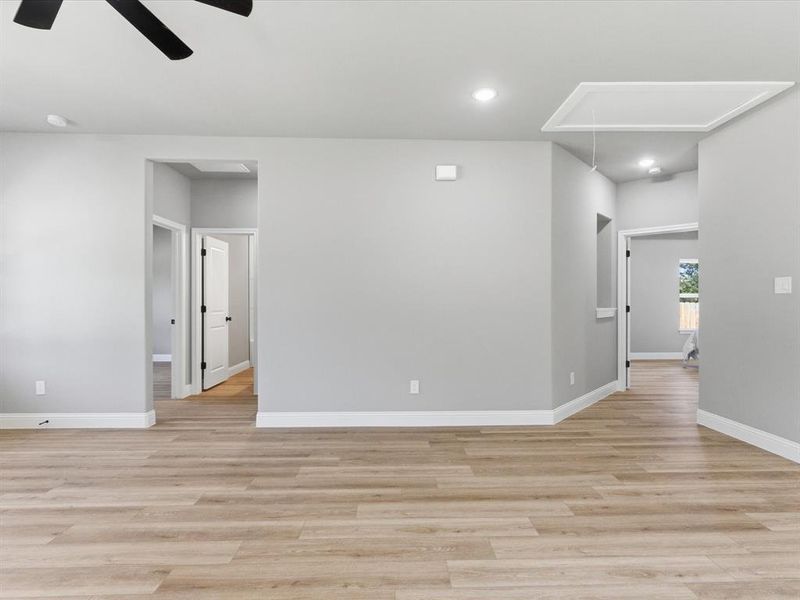 Unfurnished room with light wood-style flooring, recessed lighting, attic access, and a ceiling fan Unfurnished room with light wood-style flooring, recessed lighting, attic access, and a ceiling fan