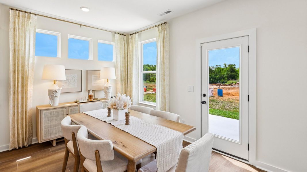 Dining area with natural lighting from windows and access to rear entrance Dining area with natural lighting from windows and access to rear entrance